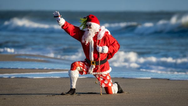 ‘Surfing Santas’ brave the freezing temps and hit the waves in the Sunshine State